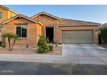 Charming single-story home featuring stone accents, desert landscaping, and an attached two-car garage at 61 W Hackberry Dr, Chandler, AZ 85248
