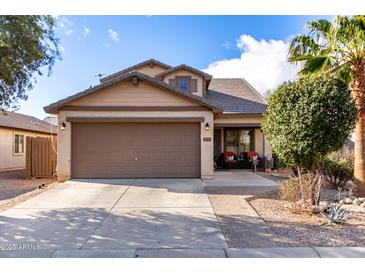 Charming single-story home with a two-car garage, desert landscaping, and a cozy front porch at 1623 W Quick Draw Way, San Tan Valley, AZ 85144