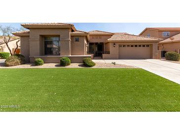 Beautiful home featuring a well-maintained lawn, elegant landscaping, and a neutral color scheme at 23935 S Sunvista Dr, Sun Lakes, AZ 85248