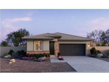 Charming single-story home with brick accents, neutral stucco, a tile roof, and a well-manicured desert landscape at 25161 W Wayland Dr, Buckeye, AZ 85326