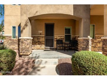 Inviting covered front porch with stone accents and seating area at 2821 S Skyline Dr # 107, Mesa, AZ 85212