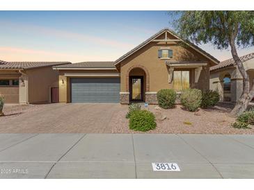 Charming single-story home featuring an attached garage and desert-style landscaping at 3816 E Rakestraw Ln, Gilbert, AZ 85298