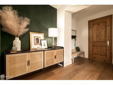 Welcoming entryway with a wooden door, stylish console table, and eye-catching decor creates an inviting first impression at 7175 E Camelback Rd # 401, Scottsdale, AZ 85251