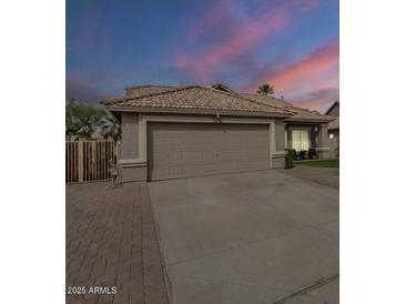 Charming single-story home with a two-car garage and beautifully maintained desert landscaping at 7252 E Nido Ave, Mesa, AZ 85209
