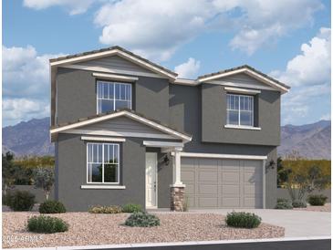 Charming two-story home featuring a two-car garage, neutral stucco, and a meticulously landscaped front yard at 9613 W Parkway Dr, Tolleson, AZ 85353