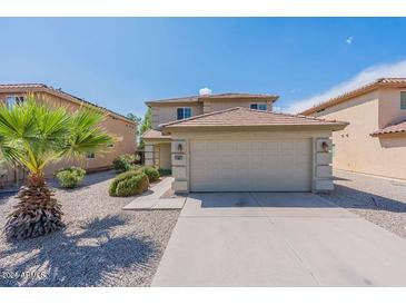 Inviting two-story home boasting a well-maintained lawn and attached two-car garage at 1361 W Roosevelt Ave, Coolidge, AZ 85128