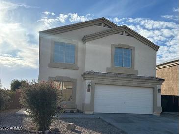 Charming two-story home featuring a two-car garage and low maintenance desert landscaping at 1492 S 218Th Ln, Buckeye, AZ 85326