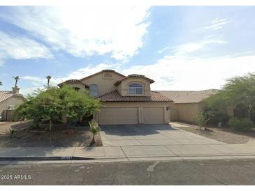 Charming two-story home with three-car garage and desert landscaping at 2117 N 123Rd Dr, Avondale, AZ 85392