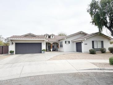 Attractive single-Gathering home with a well-manicured lawn, a 3-car garage and a neutral paint scheme at 21491 S 185Th Way, Queen Creek, AZ 85142