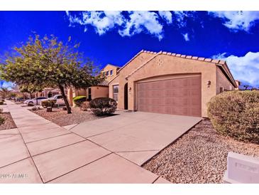 Inviting front exterior of a single-story home with a well-manicured landscape and a two-car garage at 2530 W Gaby Rd, Phoenix, AZ 85041