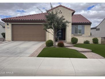 Charming home with a landscaped front yard, walkway, and spacious two-car garage at 26818 W Firehawk Dr, Buckeye, AZ 85396