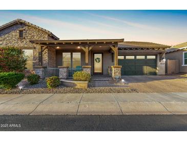 Charming single Gathering home featuring stone accents, covered porch, and a two car garage at 3110 E Cat Balue Dr, Phoenix, AZ 85050