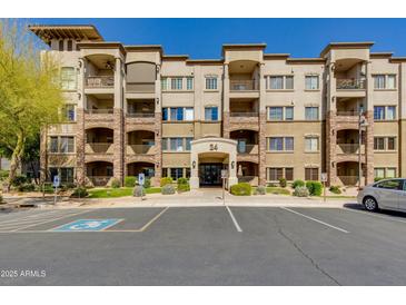 Beautiful multi-story condo building with a stone facade, covered balconies, and well-maintained landscaping at 5350 E Deer Valley Dr # 4408, Phoenix, AZ 85054