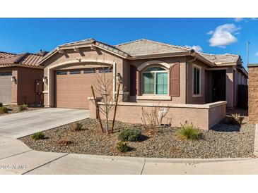 Charming single-story home with desert landscaping and a two-car garage at 7410 S 22Nd Ln, Phoenix, AZ 85041