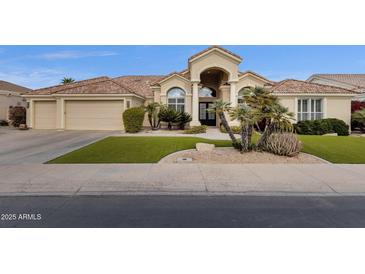 Inviting front exterior showcasing a well-manicured lawn and desert landscaping at 11256 E Palomino Rd, Scottsdale, AZ 85259