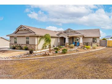 Charming single-story home boasts desert landscaping, stone accents, and a well-manicured front yard at 13729 E Rancho Laredo Dr, Scottsdale, AZ 85262