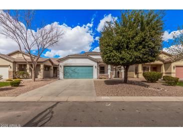 Charming single-story home featuring a blue garage door, stucco siding, and well-maintained landscaping at 1434 W Brangus Way, San Tan Valley, AZ 85143