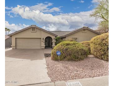 Charming home featuring a well-manicured front yard and a two-car garage at 14402 N Silverado Dr, Fountain Hills, AZ 85268