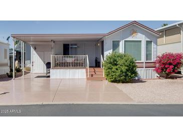 Charming single-story home featuring a covered entrance, mature landscaping, and ample parking space at 17200 W Bell Rd # 866, Surprise, AZ 85374