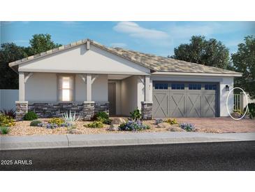 Charming single-story home featuring stone accents, desert landscaping, and a covered front porch at 17701 W Odeum Ln, Goodyear, AZ 85338