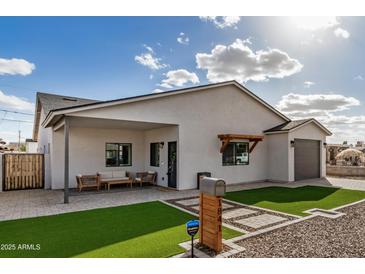 Charming single-story home with a well-manicured lawn, neutral paint, and stylish modern details at 1841 E Clarendon Ave, Phoenix, AZ 85016