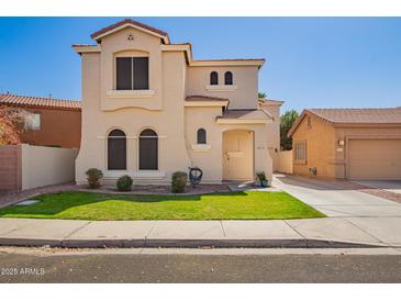 Two-story home featuring a well-manicured lawn, charming architectural details and private driveway at 2635 E Chester Dr, Chandler, AZ 85286