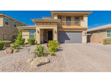 Two-story home showcasing neutral stucco, front balcony, well-maintained landscaping, and attached two-car garage at 2748 E Cherry Hill Dr, Gilbert, AZ 85298