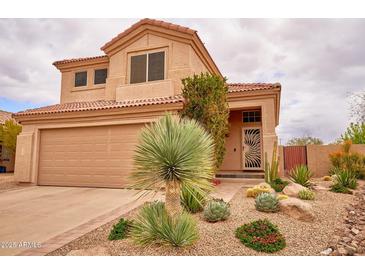 Charming two-story home with a desert landscape and a spacious two-car garage, creating a welcoming curb appeal at 4365 E Milton Dr, Cave Creek, AZ 85331