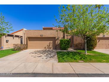 Charming single-story home with a two-car garage and well-maintained front yard landscaping at 5513 N 5Th Dr, Phoenix, AZ 85013