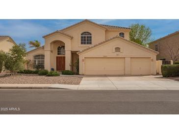 Inviting two-story home featuring a three-car garage and arched entryway at 5771 W Gail Dr, Chandler, AZ 85226