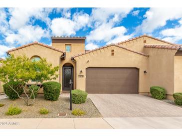 Charming single-story home with a well-manicured front yard, desert landscaping and a spacious two-car garage at 7518 E Vista Bonita Dr, Scottsdale, AZ 85255