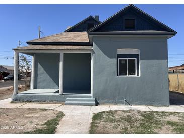 Charming exterior view of a well-maintained, two-story home with a covered porch and stylish architectural details at 824 S 3Rd Ave, Phoenix, AZ 85003