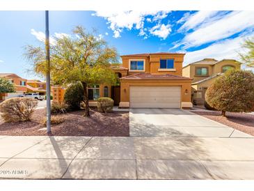 Charming two-story home featuring a well-maintained yard, a spacious driveway, and a classic two-car garage at 12462 N 75Th Ln, Peoria, AZ 85381