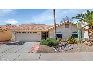 Charming home featuring desert landscaping and a two-car garage at 16224 S 40Th Pl, Phoenix, AZ 85048