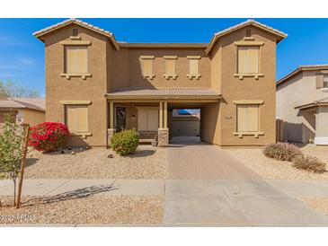Charming two-story townhome features a desert landscape and covered entryway at 16510 W Tether Trl, Surprise, AZ 85387