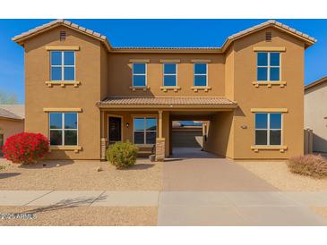 A charming two-story home with a private front entrance and desert landscaping at 16510 W Tether Trl, Surprise, AZ 85387