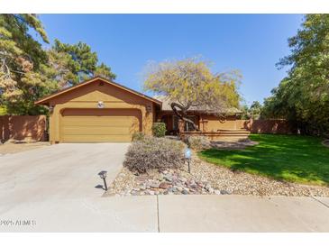 Charming home featuring a well-manicured lawn and inviting curb appeal with a beautiful desert-style front yard at 18813 N 37Th Pl, Phoenix, AZ 85050