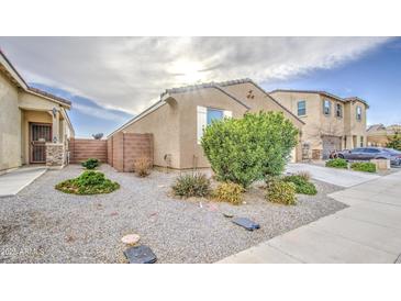 Cozy single-Gathering home featuring desert landscaping with a neutral color palette at 23649 W Watkins St, Buckeye, AZ 85326