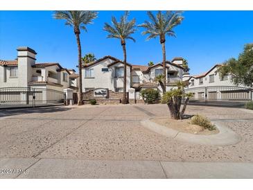Charming gated community entrance featuring beautiful landscaping and well-maintained facades at 2992 N Miller Rd # 103, Scottsdale, AZ 85251