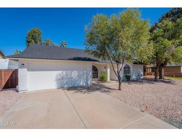 Charming home featuring a two-car garage, arched windows, and a well-maintained front yard at 3624 W Whitten St, Chandler, AZ 85226