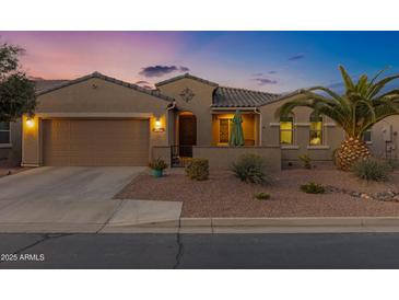 Charming single-story home featuring a two-car garage, tiled roof and desert landscaping at 42186 W Cribbage Rd, Maricopa, AZ 85138