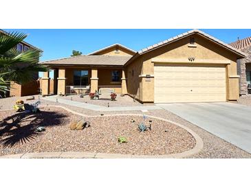 Charming single-story home with desert landscaping, a covered porch and a two-car garage at 45558 W Mountain View Rd, Maricopa, AZ 85139