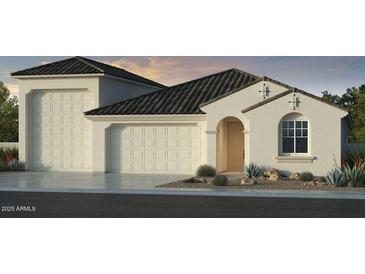 Charming single-story stucco home featuring a tile roof, front-facing garage, and a landscaped front yard at 5206 W Top Hand Trl, Laveen, AZ 85339
