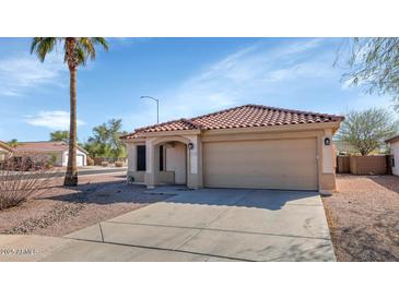 Charming single-story home with a tile roof, desert landscaping, and a two-car garage at 10461 E Birchwood Ave, Mesa, AZ 85208