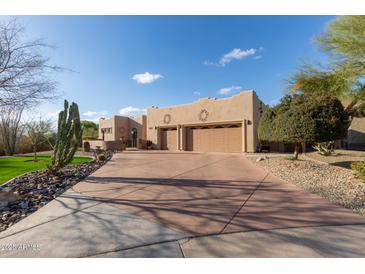 Charming home featuring a spacious driveway, a three-car garage, and desert landscaping at 20212 E Appaloosa Dr, Queen Creek, AZ 85142