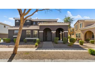 Charming two-story home with a welcoming arched entryway and well-maintained landscaping at 2983 E Harrison St, Gilbert, AZ 85295