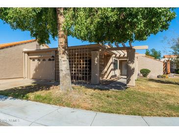 Charming single-story home with a well-maintained front yard and a cozy, covered entryway at 315 Leisure World --, Mesa, AZ 85206