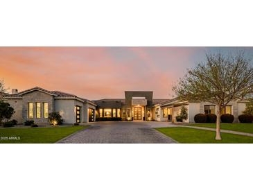 Beautiful single-Gathering home featuring a well-manicured lawn, brick driveway, and stunning architecture at 3392 E Gemini Ct, Chandler, AZ 85249