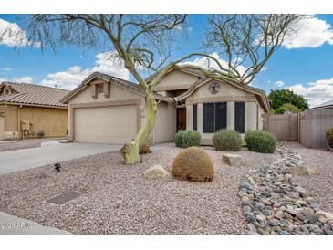 Inviting single-story home featuring a two-car garage and desert landscaping at 6664 W Rose Garden Ln, Glendale, AZ 85308