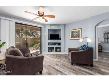 Comfortable living room with a ceiling fan and sliding glass door to a patio area at 705 W Queen Creek Rd # 1059, Chandler, AZ 85248